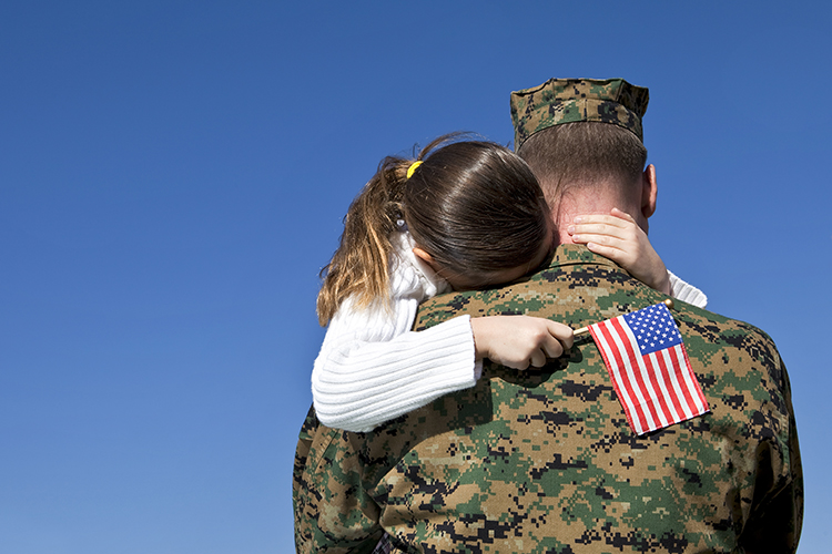 Dad in Military with daughter hugging him as he says goodbye